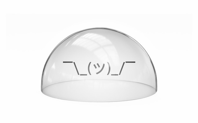 a "shruggie" emoticon in isolation under a glass dome