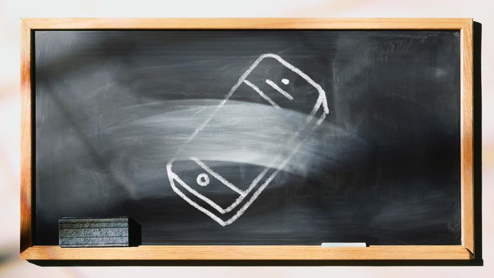 A chalkboard with a picture of a phone that's half erased