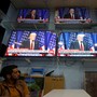 An Afghan man watches TV coverage of President Trump's address.