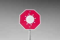 A coronavirus on a red stop sign