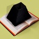 A book with the opening to a black hole emerging from its center