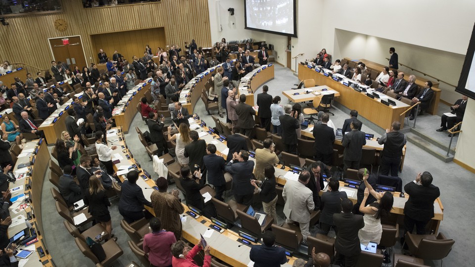 Delegates give a standing ovation after approving the treaty on July 7, 2017.