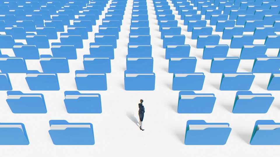 person looking back at rows and rows of file folders