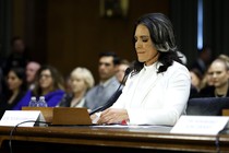 Tulsi Gabbard sits in front of a microphone during her Senate hearing