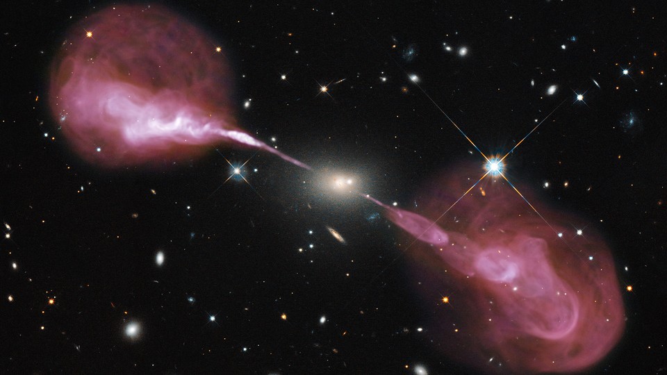 The Very Large Array sees fountains of hot gas erupting from a beastly black hole in the heart of a large galaxy known to radio astronomers as Hercules A. For millions of trillions of miles, these jets shoot through space, finally slowing when they reach ancient gaseous hiccups left behind by this galaxy’s earliest days of star-forming fury.