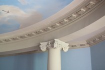 Close-up of a column holding up a ceiling painted to look like the sky