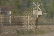a double exposure of curtains on a railroad sign and building
