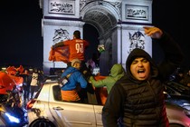 Morocco fans celebrate the team's defeat of Portugal in front of the Arc de Triomphe, in Paris.