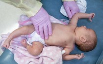 a photo of an infant in a hospital care setting, taken from above