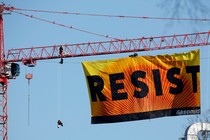 A banner reading “RESIST” hangs off a crane near the White House in Washington, D.C.
