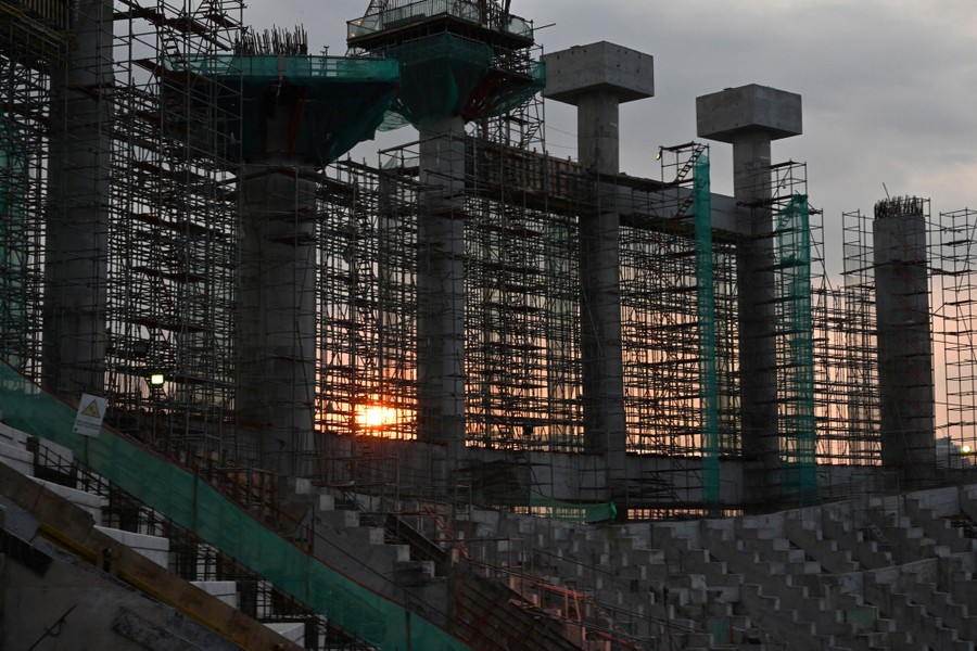 Tall columns stand among scaffolding in a large construction site.