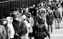 Photo of people in New York City queuing up to receive at-home COVID-testing kits