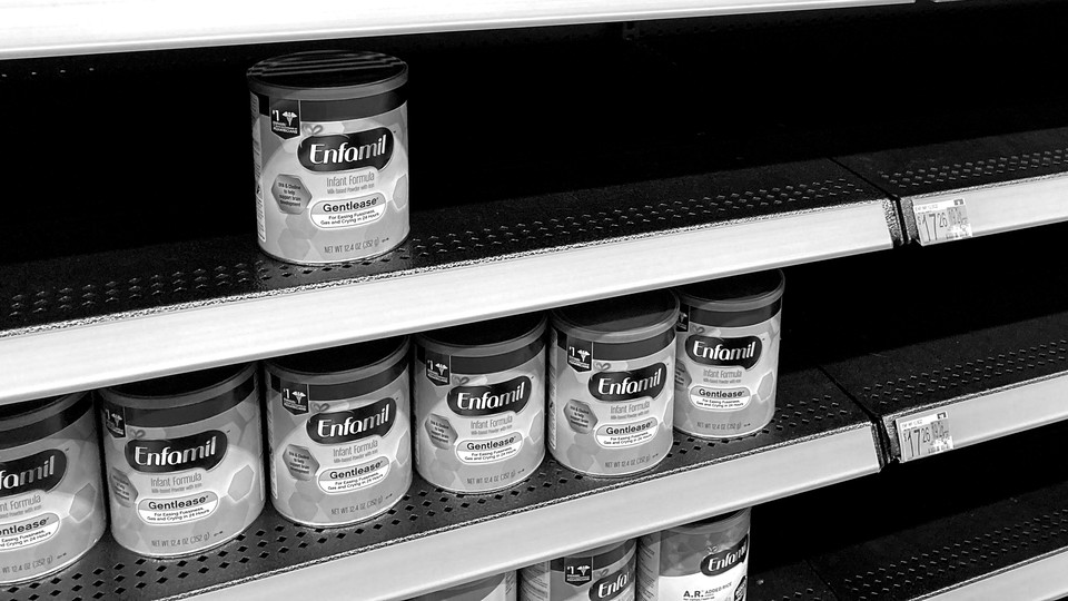 Store shelves of infant formula, half-empty