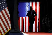 The silhouette of J. D. Vance in front of an illuminated American flag