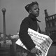 Boy selling chicago defender newspaper in 1942
