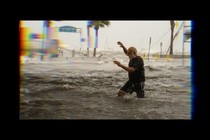 A man tries to move through floodwater during Hurricane Helene.