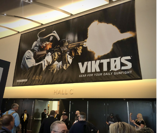 An ad by Viktos displayed at the 2020 SHOT Show, which depicts a Revolutionary War soldier firing a modern-day rifle