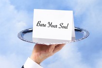Hand holding a platter with a "bare your soul" invitation card