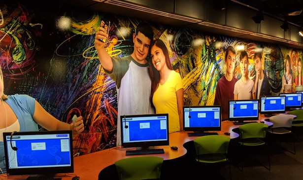 Murals of teenagers on the wall of the teen space in the Brownsville Public Library's main branch