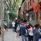 A long line of students and parents tumbles onto the New York City sidewalk.