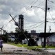 A woman looks over damage to a neighborhood caused by Hurricane Ida on August 30, 2021, in Kenner, Louisiana.