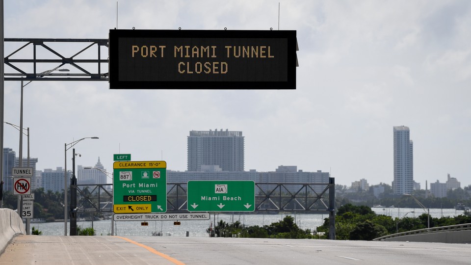 A road sign reads, "Port Miami tunnel closed."