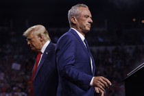 Robert F. Kennedy Jr. walks past Republican presidential nominee Donald Trump during a campaign event