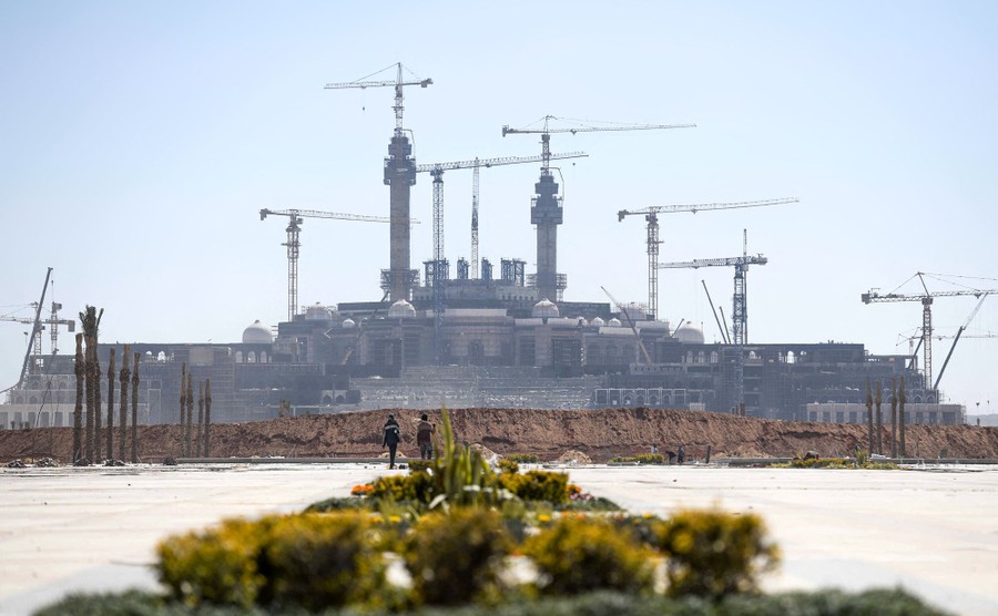 A distant view of an enormous mosque under construction