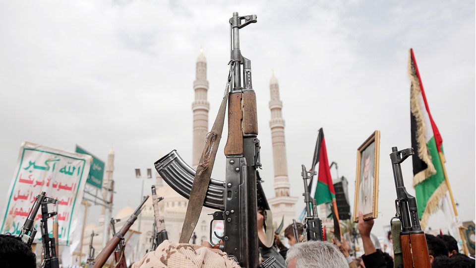 Yemenis brandish rifles, flags of Yemen and Palestine, and Houthi emblems while chanting slogans during a demonstration against Israel's latest aerial attacks to hit Yemen's port city of Hudaydah in the ongoing war on Palestine, on July 26, 2024, in Sana'a, Yemen.