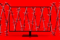 A computer screen tangled in barbed wire against a red background