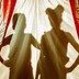The silhouettes of a woman and a child behind red-and-gold-striped curtains