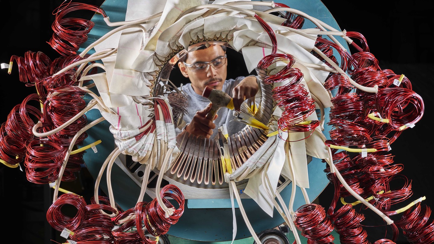 Photo of a person working on a complex motor