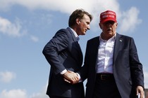 A photograph shoes Glenn Youngkin shaking Donald Trump's hand