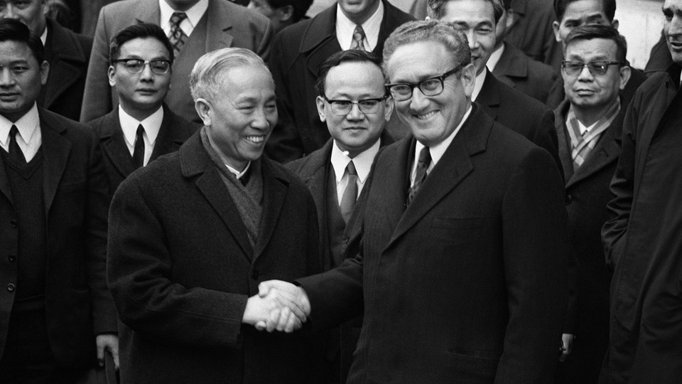 Henry Kissinger shakes hand with Le Duc Tho, leader of North Vietnam delegation, after the signing of the Paris Peace Accords on January 23, 1973.