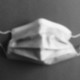 A fuzzy image of a surgical mask in gray scale