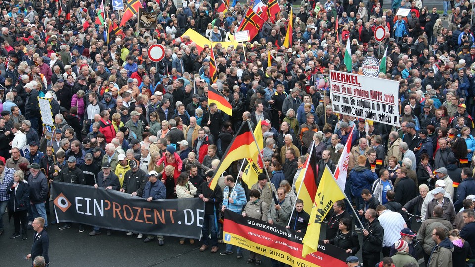 Supporters of the anti-Islam movement "Patriotic Europeans Against the Islamization of the West" (PEGIDA) march with flags.
