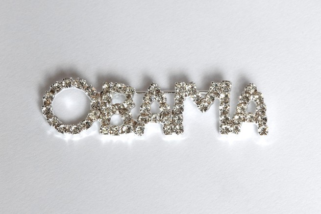 a rhinestone-encrusted broach reading "Obama"