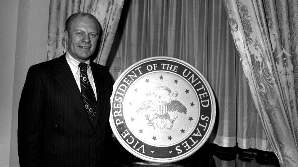 A photograph of Gerald Ford in front of a lectern bearing the seal of the vice president.