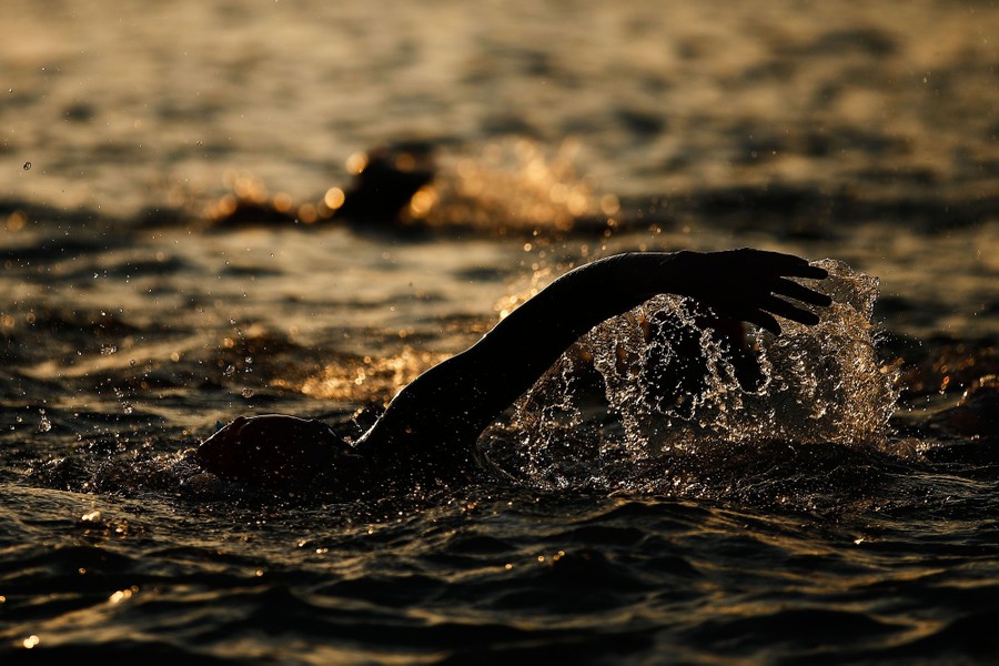 A swimmer's arm splashes during a race.