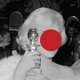 A woman in a dress with her face covered by a red circle
