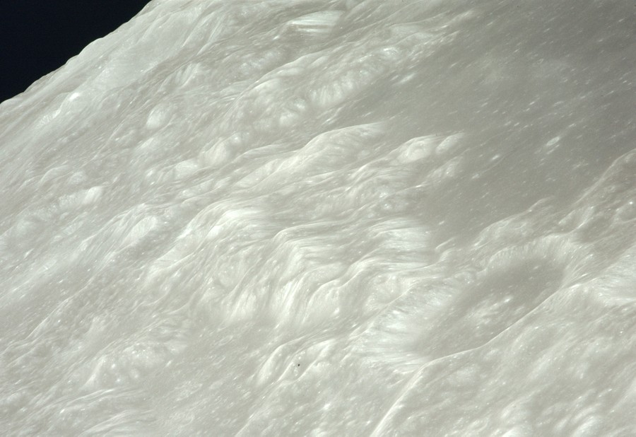An orbital view of the gray and hilly surface of the moon