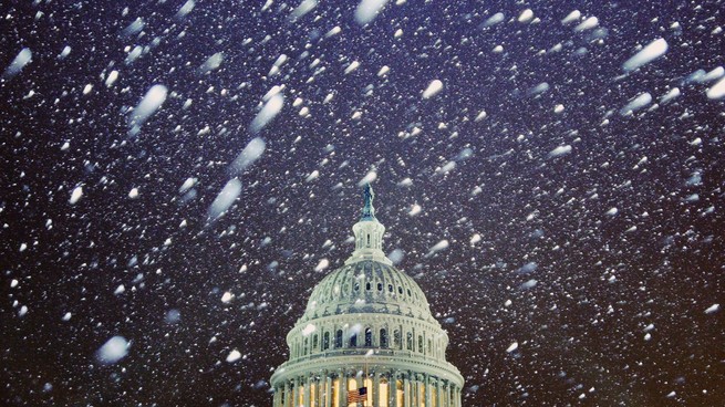 Snow falls over the U.S. Capitol Building on Monday, Jan. 3, 2022.