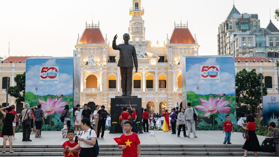 An image of people walking on a pedestrian street near the Ho Chi Minh Monument in Ho Chi Minh City, Vietnam