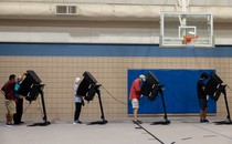 Voters casting their ballots in a gymnasium