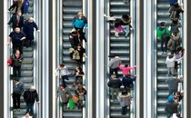 shoppers on an escalator