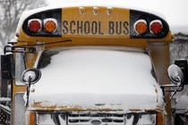 A school bus covered in snow.