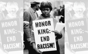 woman holding sign "Honor King: End Racism!"