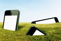 large smartphones stuck in grass