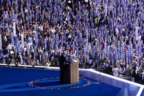 Joe Biden gives a speech at the DNC surrounded by "We Heart Joe" signs