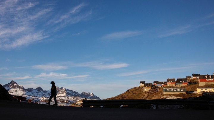 A man walks through Tasiilaq, Greenland.